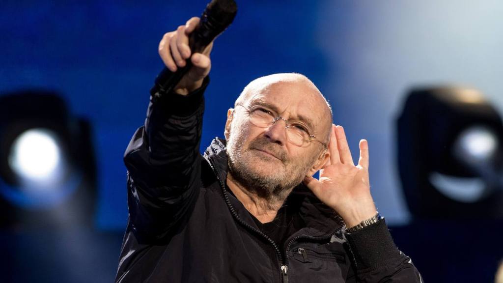 Phil Collins holding a mic