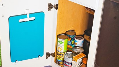 Storing cutting boards on hooks in a cabinet