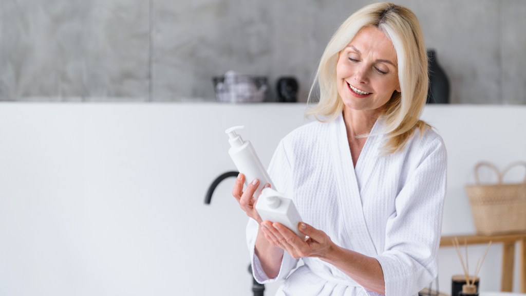 Mature woman deciding between shampoo or conditioner first