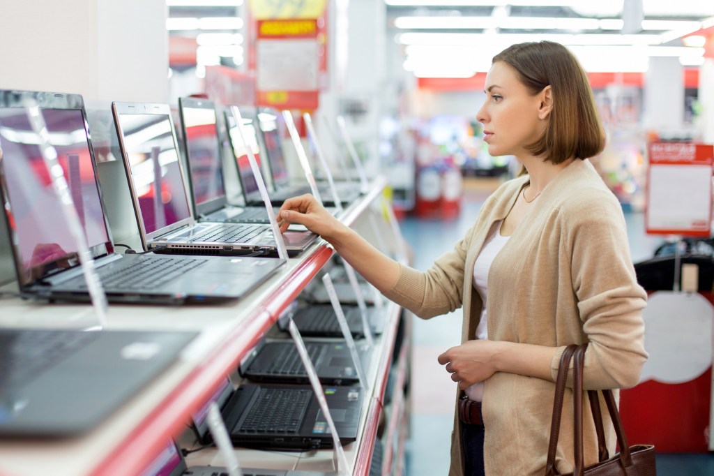 woman testing out laptop before she buys