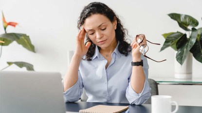 Woman at her desk not feeling well