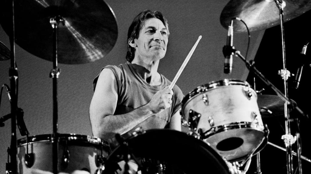 Charlie Watts playing drums; Rolling stones members