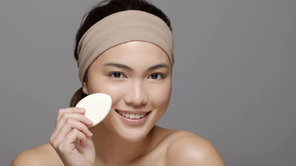 Uses for Pantyhose: Young woman using make up sponge