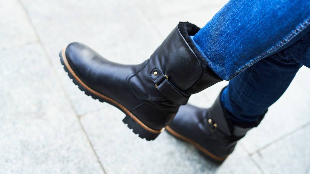 Uses for Pantyhose: close-up of boots of a woman sitting on the street wearing jeans during the day, side view