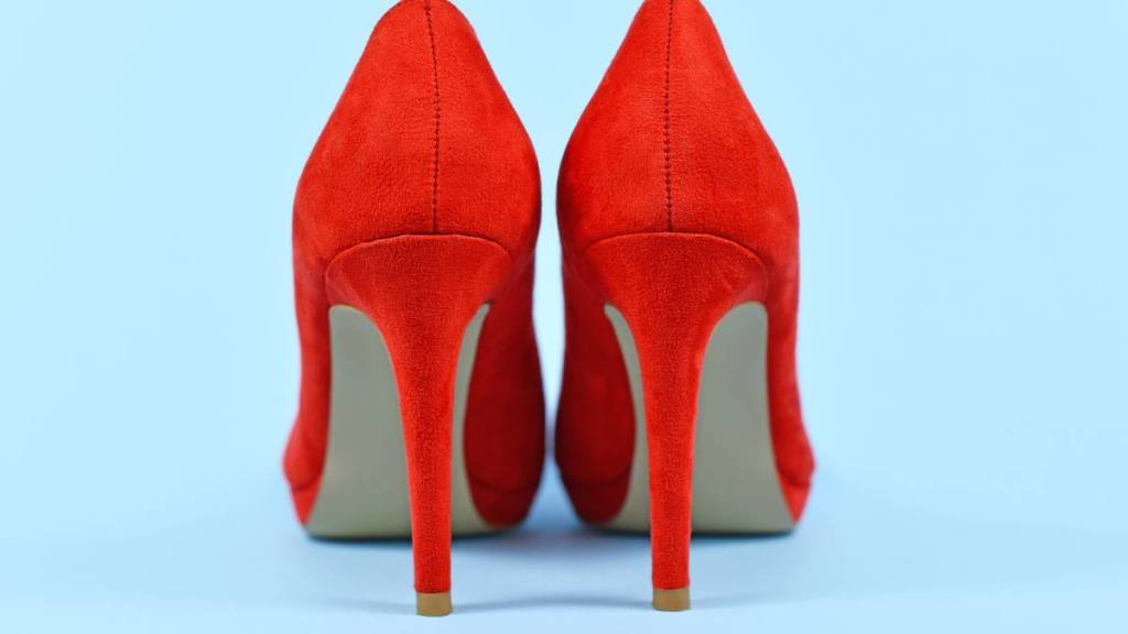 Uses for Pantyhose: Back view of elegant red synthetic suede leather high heel woman shoes on blue background