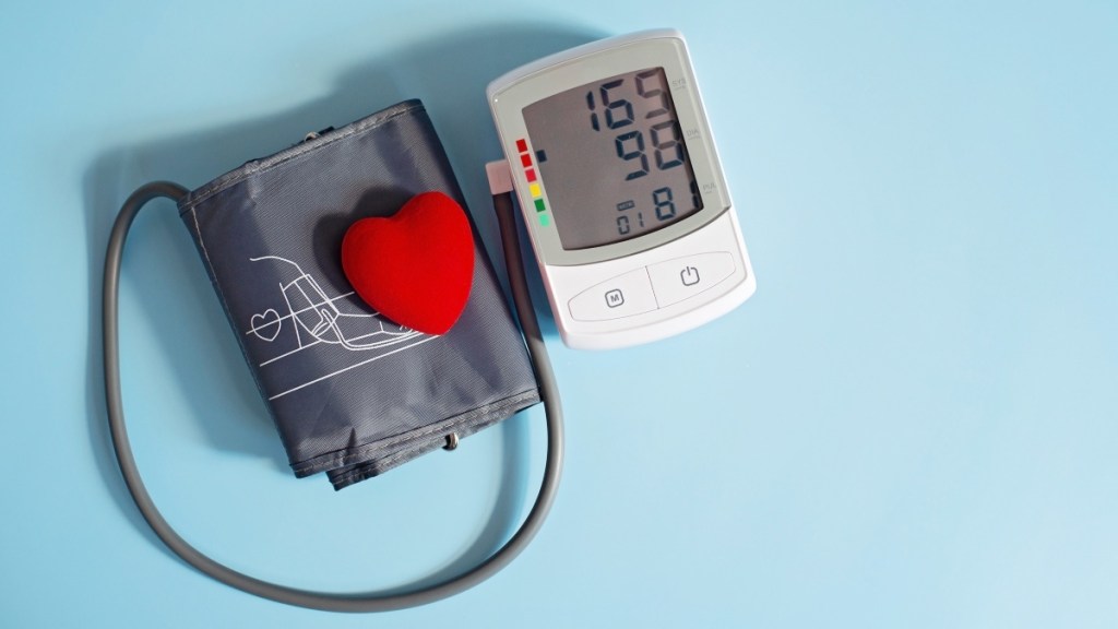 A blood pressure cuff with a red heart on a blue background