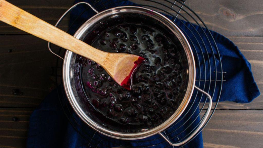 blueberry compote in pot with wooden spoon