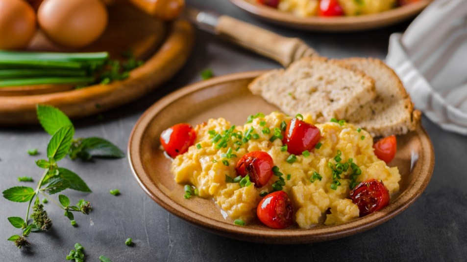 Scrambled eggs with herbs, roasted tomatoes, chive