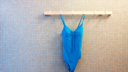Blue bathing suit hanging in a changing room