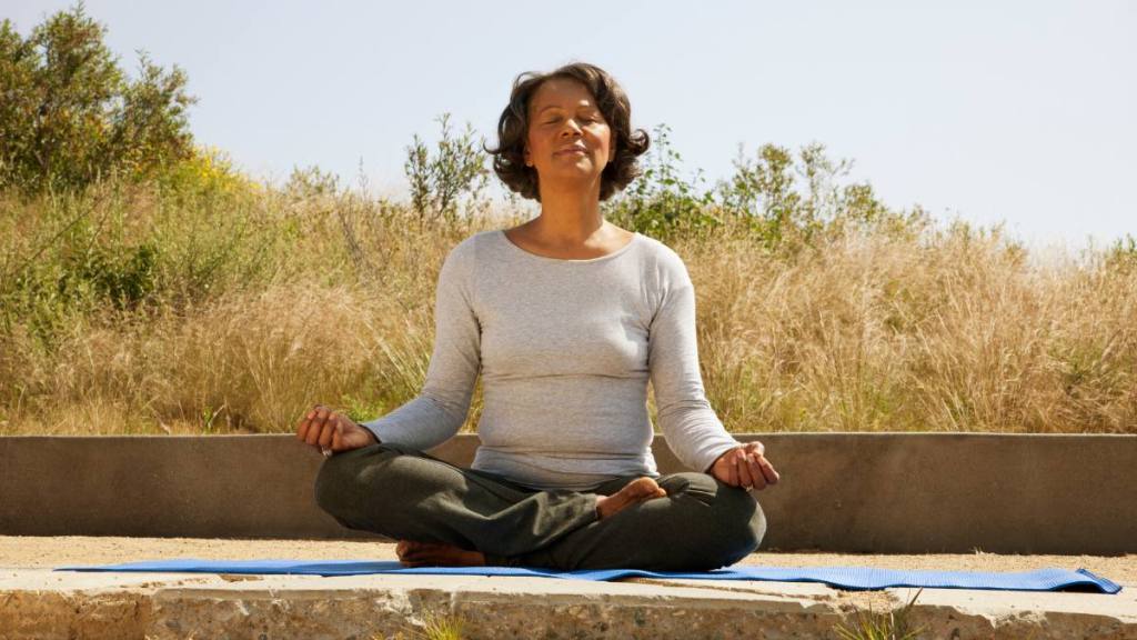 woman doing simple yoga pose; frequent urination