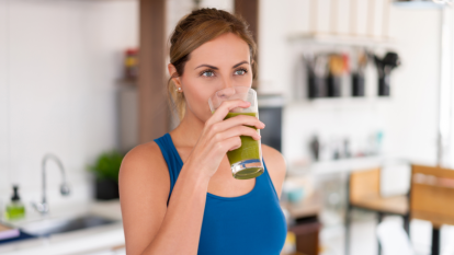 are powdered greens worth it: Portrait of a beautiful woman drinking a green detox juice - healthy eating concepts
