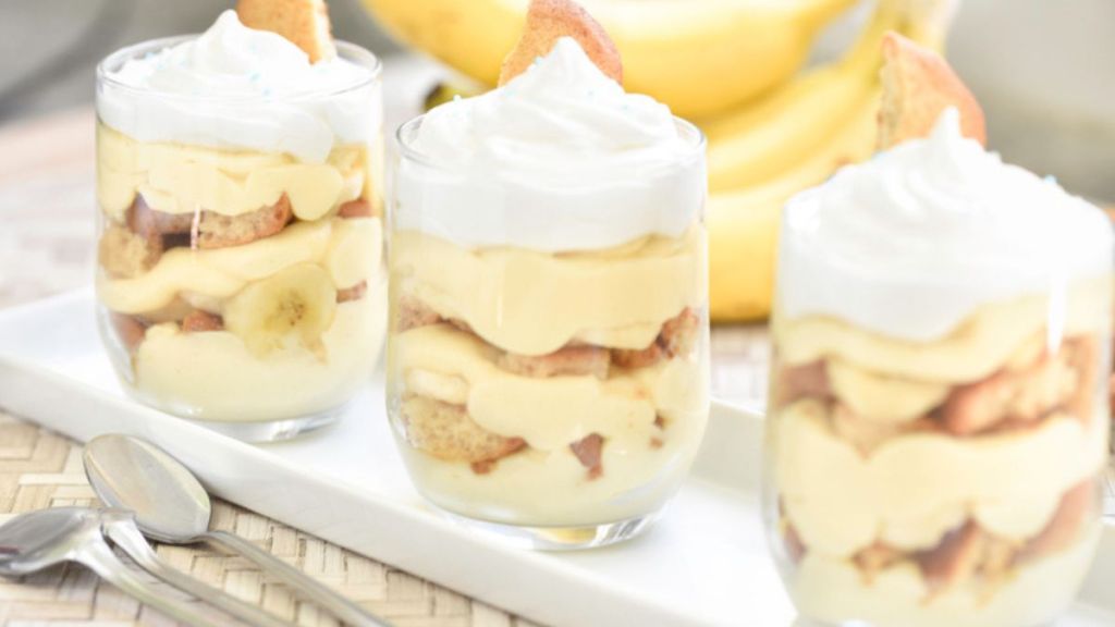 banana pudding cups on white platter with meringue