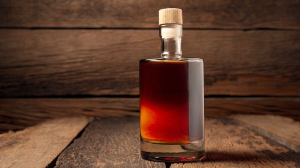 Kentucky whiskey bottle on wooden surface used for bourbon meatballs