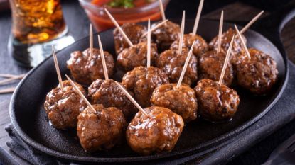 bourbon meatballs with toothpicks on serving plate