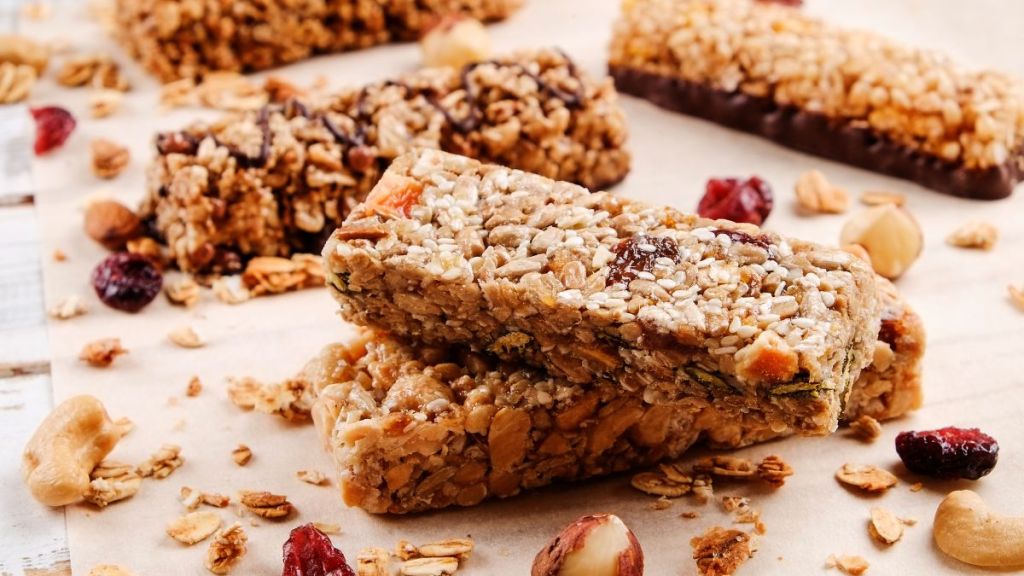 homemade granola bars with dried cranberries and raisins on white background