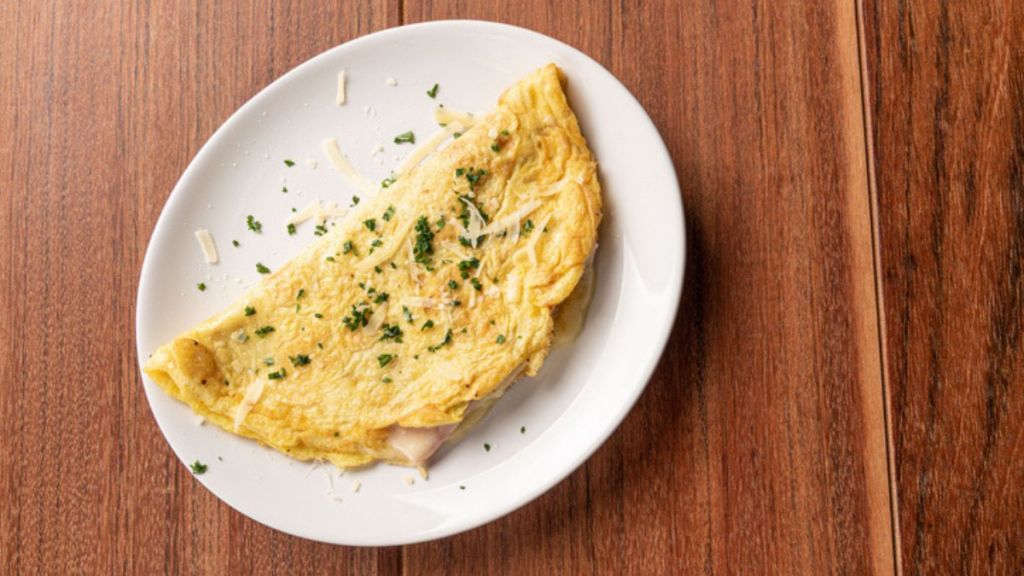 microwave omelette with cheese and chives on white plate