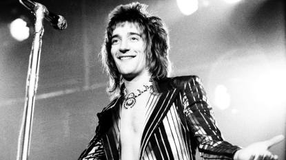 man on stage smiling; rod stewart greatest hits