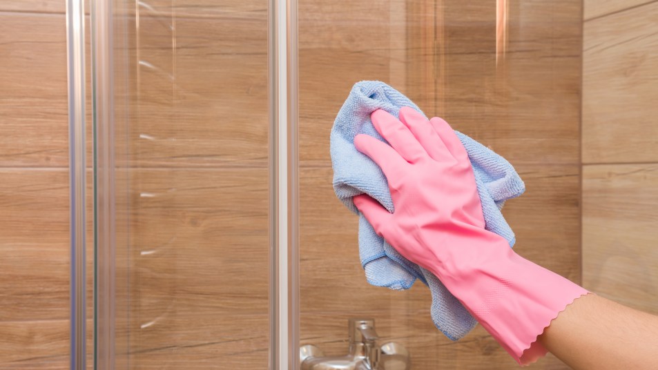 glove hand cleaning glass shower door