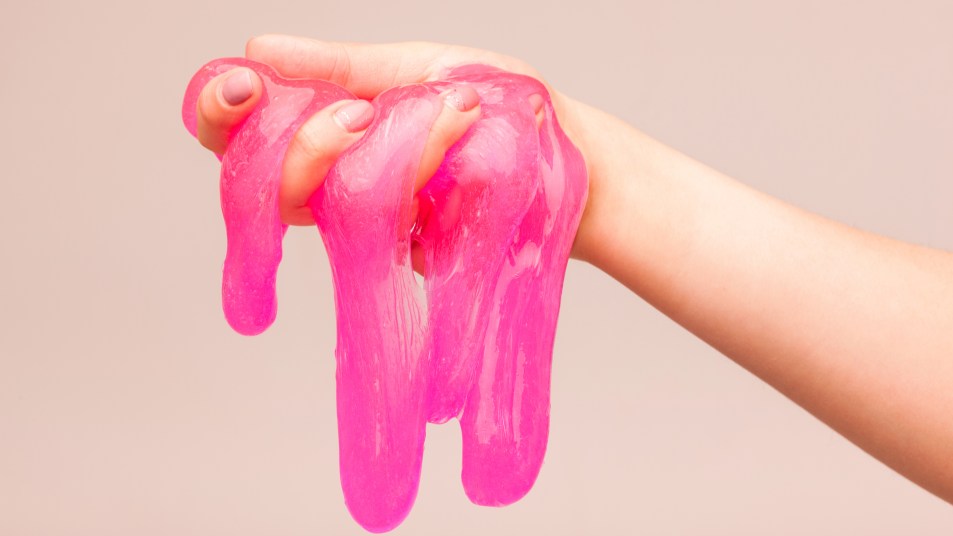 A hand holding pink slime