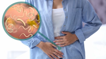Woman clutching stomach with a close-up of intestinal parasites