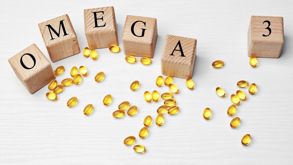 omega-3 pills and children's blocks spelling out OMEGA 3