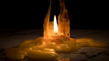Candle melted down so candle wax is adhered to the table