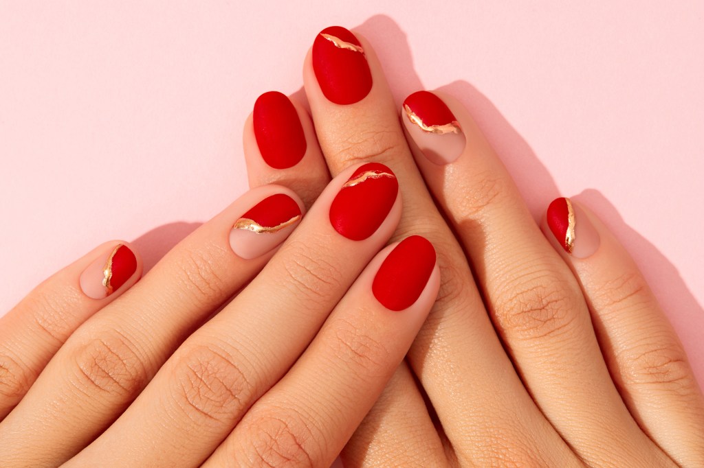red nails with gold detailing for nail designs 2023.