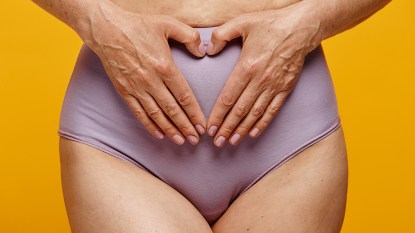 Woman over 50 with her hands on her panties worrying about her vagina
