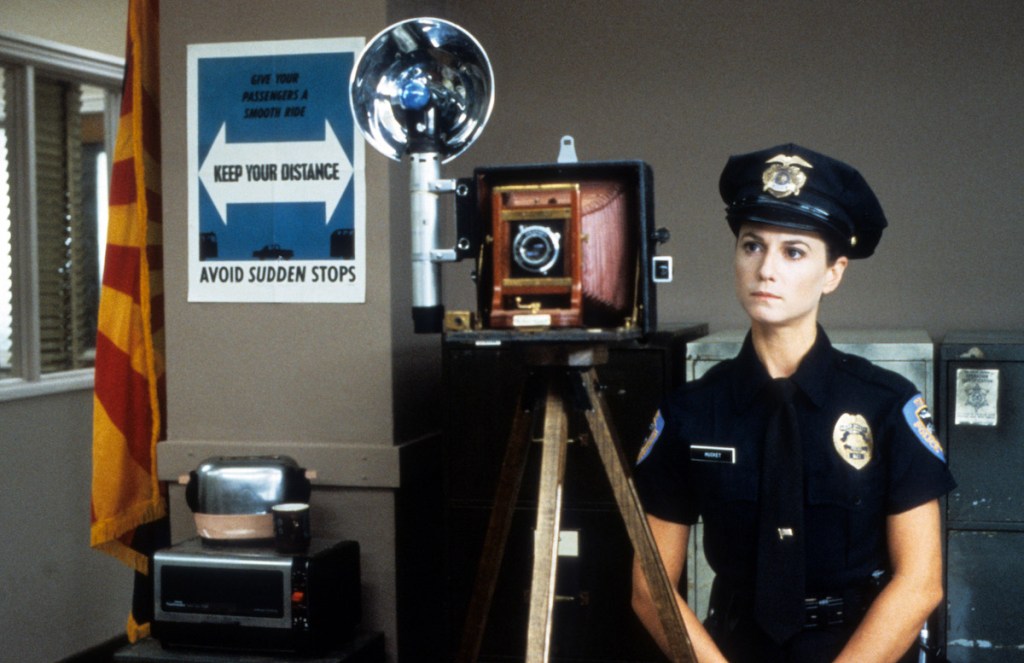 Holly Hunter photographs in a scene from the film 'Raising Arizona', 1987