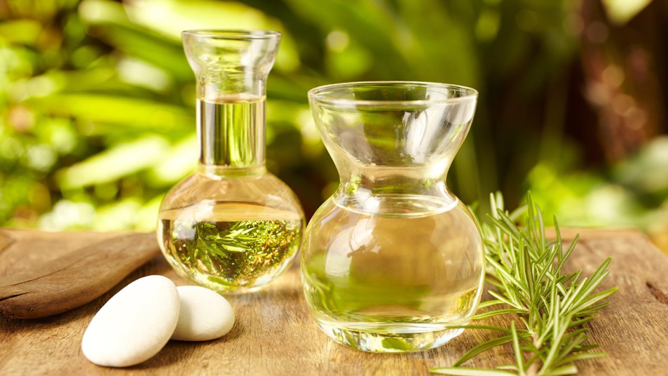 DIY rosemary oil in small vials that will help drive hair growth