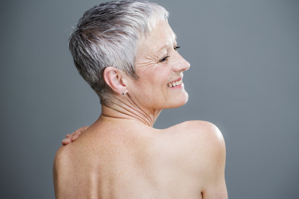 Woman with gray hair looking to the side with her back showing