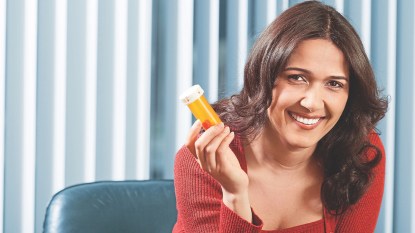 woman holding prescription bottle