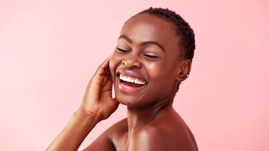 Black woman with glowing skin from the benefits of body butter