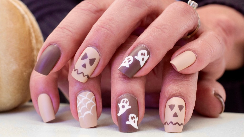 Brown and nude nails with Halloween designs.