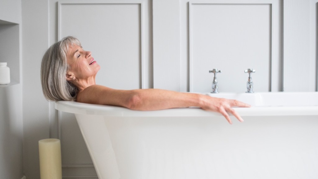 A woman with short grey hair soaking in a tub to prevent diabetes