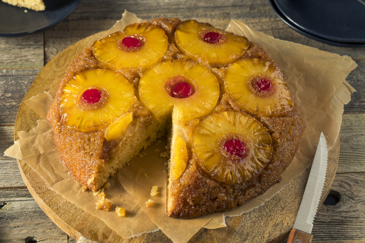 Pineapple upside down cake with a slice cut out of it