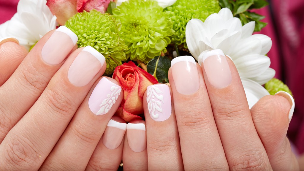 Beautiful hands with polygel nails in a French tip design