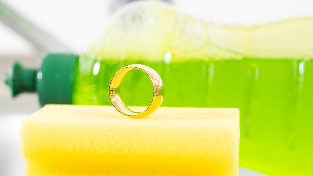 wedding ring sitting on  sponge with dish soap in the background, how to clean ting at home