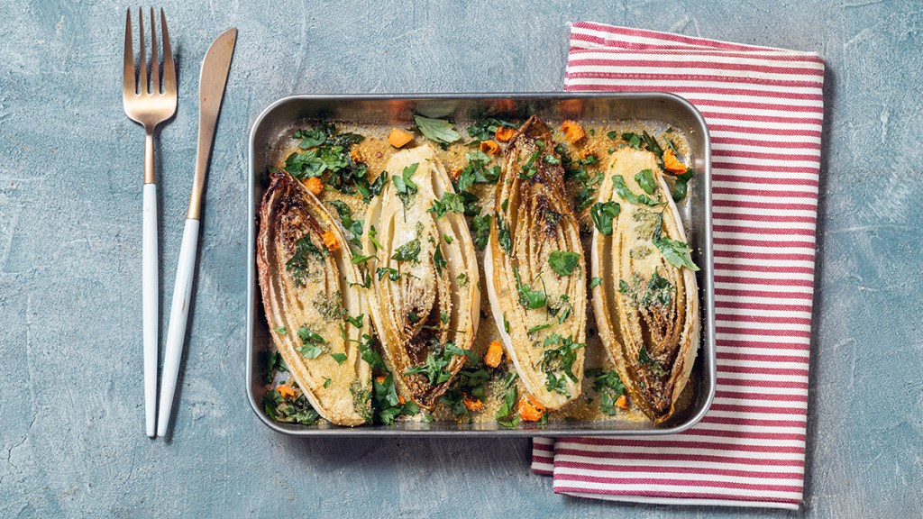 Baked endive sprinkled with breadcrumbs — endive is considered a bittter green even though mostly white