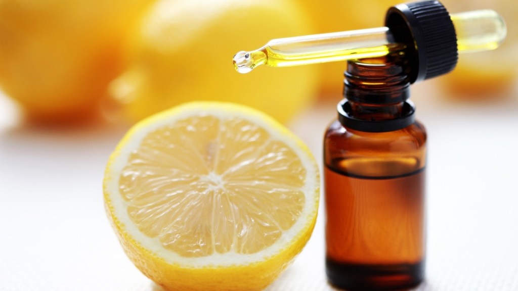 A fresh lemon beside lemon essential oil for congestion