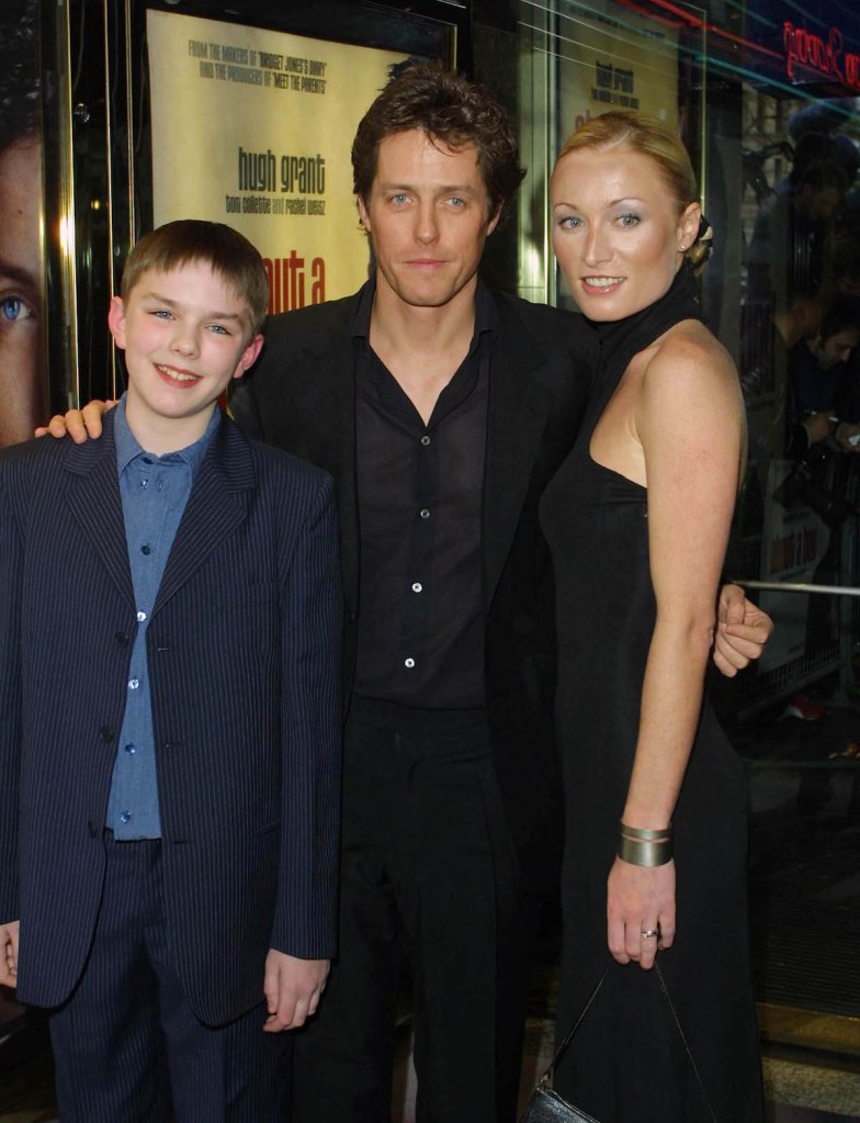 LONDON - APRIL 14: British actors Nicholas Hoult and Hugh Grant and Irish actress Victoria Smurfit attend the UK film premiere of "About A Boy" screened at the Empire Leicester Square on April 14, 2002 in London. (Photo by Gareth Davies/Getty Images)