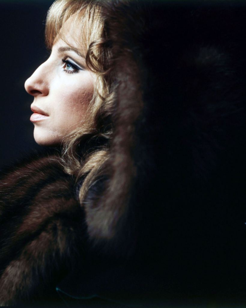 Barbra Streisand in profile wearing a fur coat in 1970