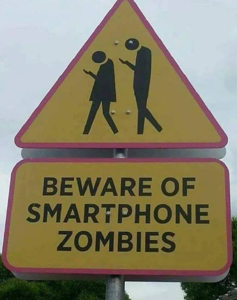 Funny signs: People looking at their phones, not paying attention, "Beware of the smartphone zombies"