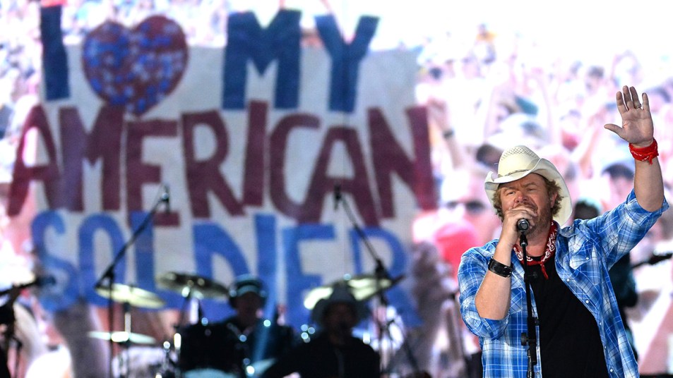 Toby Keith performing for troops Country Songs that Honor Veterans