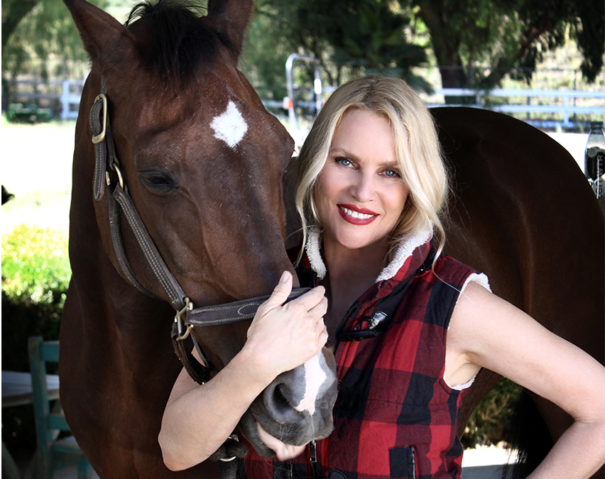 Nicollette Sheridan with  one of the horses on her farm