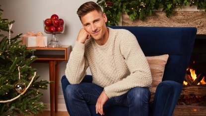 Andrew Walker posing in room with Christmas decor