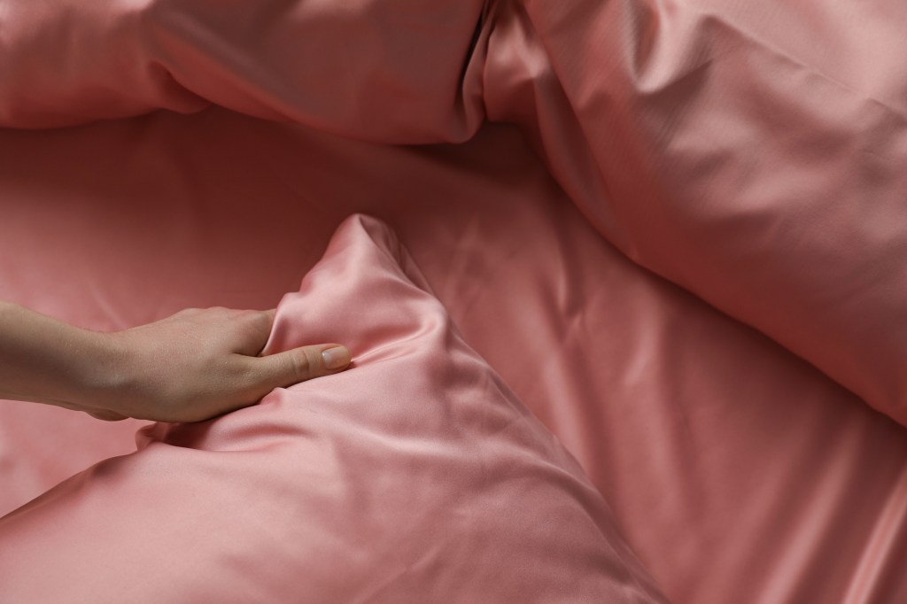 Close up of silk pillowcase and bed sheets