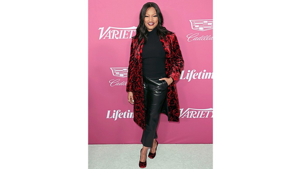 Garcelle Beauvais wearing a black top and pants with velvet accessories