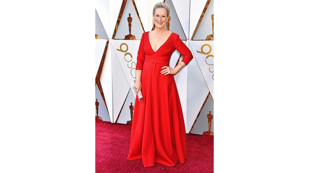 Meryl Streep wearing a long red dress, an example of holiday party outfits