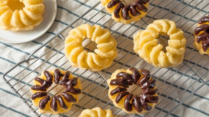 A batch of crullers on a wire rack